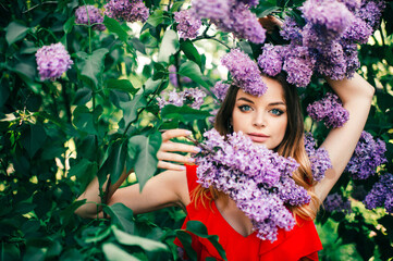 Young beautiful girl posing among the flowering tree