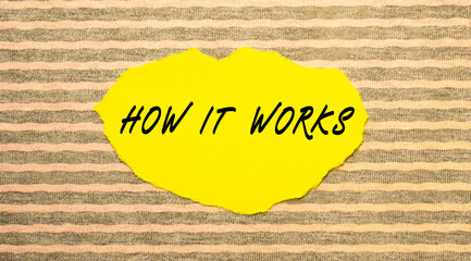Yellow torn paper with the text HOW IT WORKS on a gray-pink background.