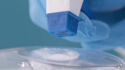 Close-up of spray disinfection by spraying on a plastic surface with an antiseptic solution to decontaminate a medical device.