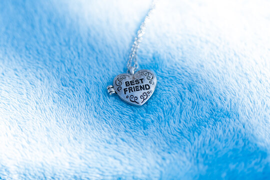 Pendant Best Friend Heart Necklace Shoot Outside In A Summer Day Closeup. Selective Focus. High Quality Photo