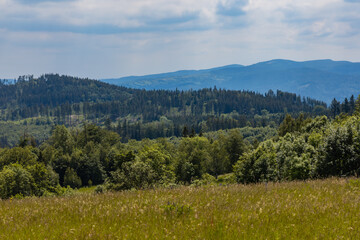 Beautiful panorama of Kaczawskie mountains with big fields and trees around © Pawel-Wierzchowski