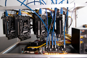 Mining farm at home. Station for the extraction of digital cryptocurrencies such as bitcoin, ethereum, and other altcoins. Close-up. Video cards for cryptocurrency mining. The array of GPUs for mining