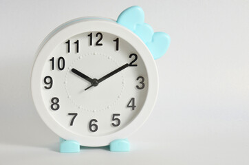 Cute white clock on a white background.