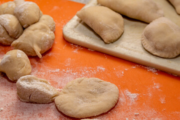 pieces of raw dough on an orange surface