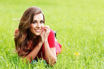 Smiling woman laying on grass