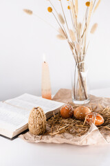 candles, painted eggs and bible. easter at home