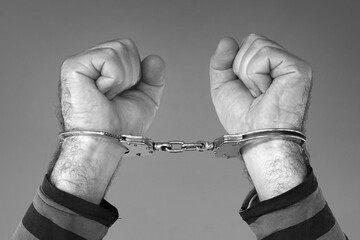 Black and white photography closeup handcuffed hands