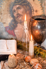 candles, paited eggs, willow branches and bible. vintage icon. easter at home