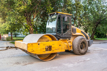 Yellow construction roller for road repair at a construction site. No people