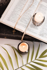Easter evening with palm leaves, candles and bible next to the icon, Easter theme