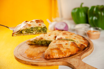 Green chicken tikka stuffed naan cooked in a wood fired oven, food fusion.