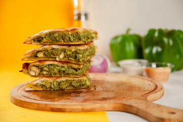 Green chicken tikka stuffed naan cooked in a wood fired oven, food fusion.