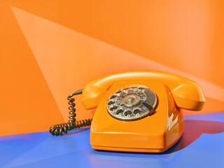Vintage yellow telephone on the table