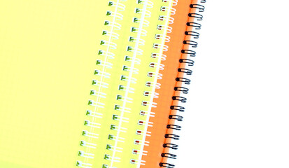 School notebooks with coil spring and color cover isolated on white background. Back to school. Stationery. Copy space. Selective focus.