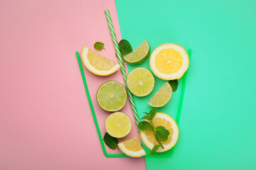 A glass made of lime and lemins on colorful background.