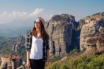 Woman tourist standing with a beautiful view to Meteora , Greece