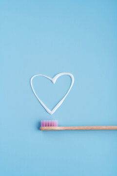 Eco-friendly trendy bamboo toothbrush. Popular toothbrushes. Hygiene trends. Top view with toothpaste