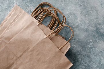 paper bags on gray background. Craft paper package with twisted handles.