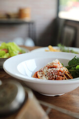spaghetti Bolognese with italian sausage and tomato sauce with parmesan cheese and basil
