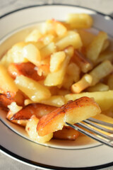 fried potatoes with butter in a plate in the sun