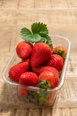 New harvest, plastic box of ripe red sweet strawberry ready to eat