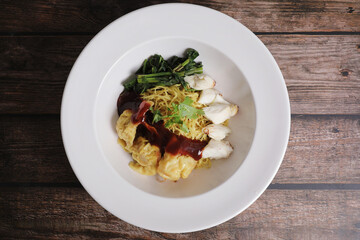 Shrimp dumpling noodles and crab meat on wood background