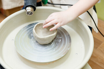 the child sculpts from clay