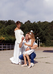 Fototapeta premium family taking a walk in the park blowing bubbles