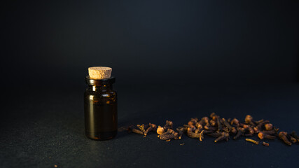 Aromatherapy at home for mind and body fulfilment. Essential oil vintage bottle surrounded by clove...