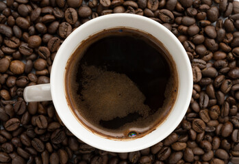 coffee cup on coffee beans