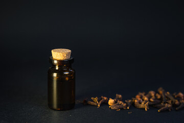 Aromatherapy at home for mind and body fulfilment. Essential oil vintage bottle surrounded by clove...