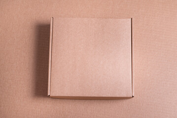 Brown cardboard flat box on brown background