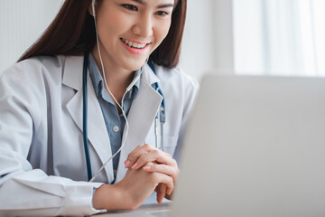 Asian therapist woman doctor is online visiting with a patient on the internet application. Her...