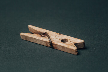 single wooden laundry washing peg on black background. High quality photo