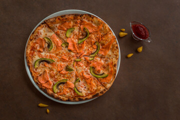 Pizza with salmon and avocado on a plate