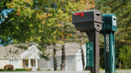 Two typical American outdoors mailboxes. Clear sunny day.