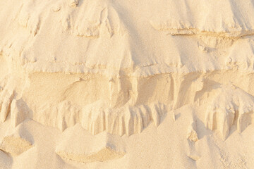 Sand on the beach for background. Brown beach sand texture as background.