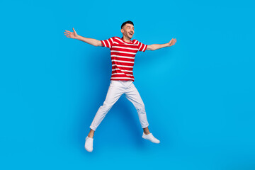 Fototapeta na wymiar Full length photo of funky cheerful young man jump up star shape isolated on pastel blue color background