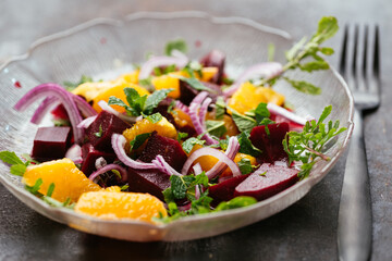 Fototapeta na wymiar Home made beet and orange salad with mint and arugula