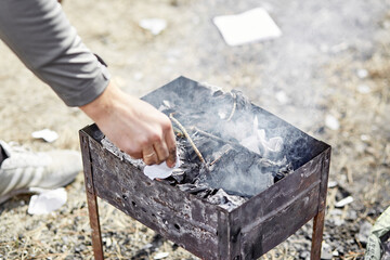 Backyard picnic. The man prepares the brazier
