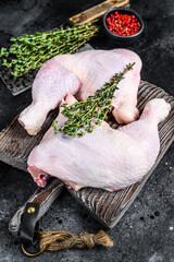 Fresh raw chicken legs on a cutting board. Black background. Top view