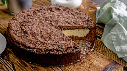 Homemade chocolate cake with curd filling on a wooden table, close-up