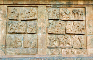 Bas relief ancient sculptures carved on the walls of historical Brihadeeswarar temple in Thanjavur, Tamilnadu. Indian rock art relief carvings of ancient God sculptures in temple walls in Tamilnadu.
