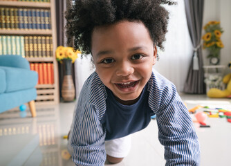 Happy black people African American child with toy at home 