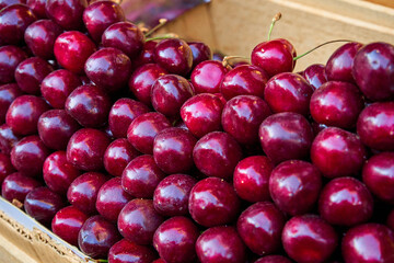 Ripe sweet red cherries. The street counter is a display case with beautifully neatly arranged fruits. Turkish style fruit layout
