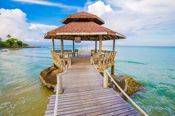 Old wood bridge to sea beach with colorful sky cloud