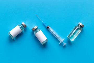 Naklejka premium Coronavirus vaccine ampoules with syringe. Vaccination concept