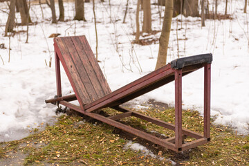Outdoor exercise equipment in the park. Outdoor bench for sports.