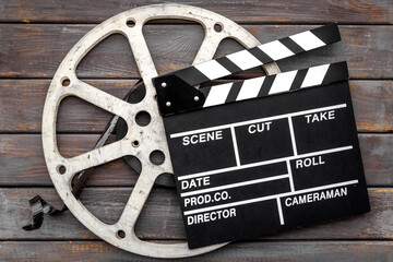 Movie film reel with clapperboard. Cinema concept