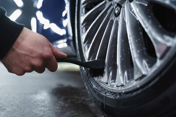 washing car wheels in garage.